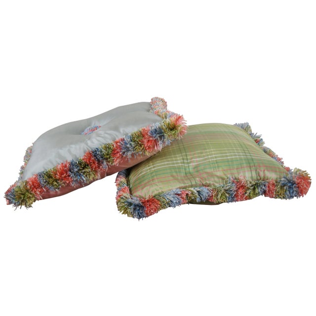 Pair of down filled throw pillows, one blue on one side and pink on the other accented with a French braid knotted button...