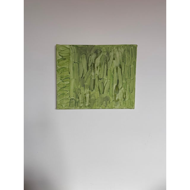 This abstract acrylic painting on canvas features a monochrome green color palette with soft vertical and horizontal...
