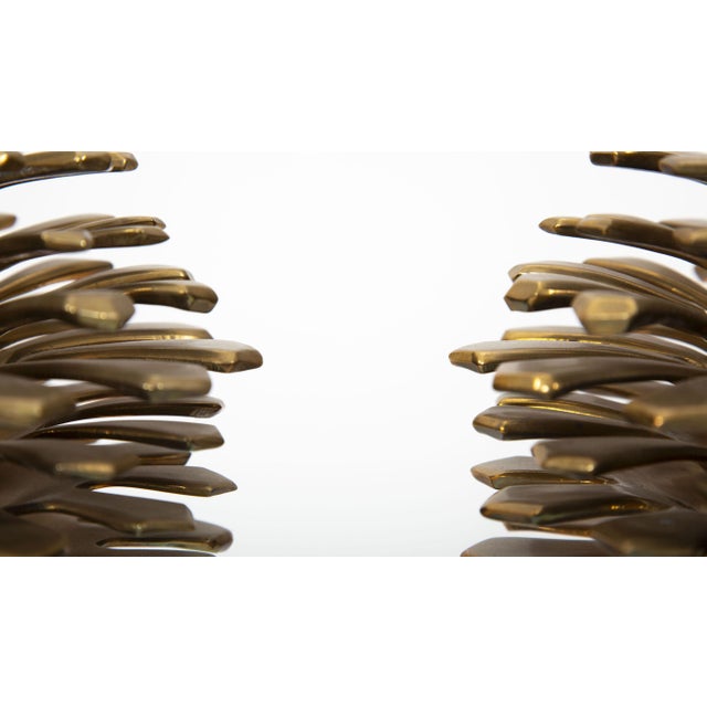A striking pair of mid-19th century brass pinecone sculptures, each finely cast and assembled with layered, radiating...