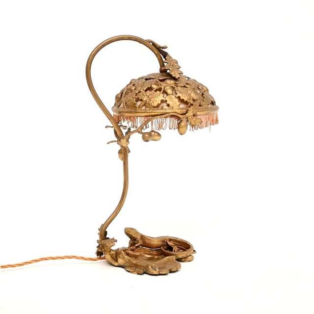 An exceptional antique French Art Nouveau bronze desk lamp. This is stamped beneath the base made in France, and is signed...
