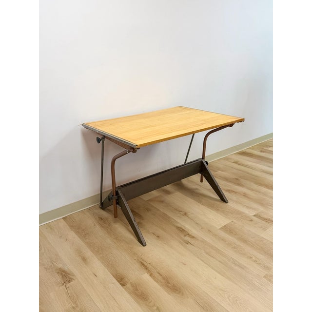 This clean and well-built vintage Mayline style drafting table with full 90-degree pivot top is a practical and...