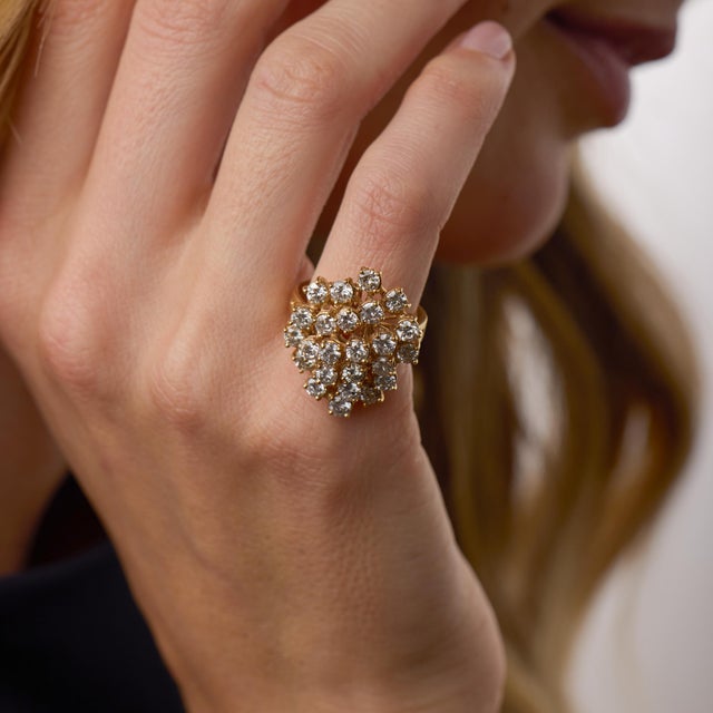 This bold vintage cocktail ring showcases an impressive cluster of 24 round brilliant cut diamonds totaling approximately...