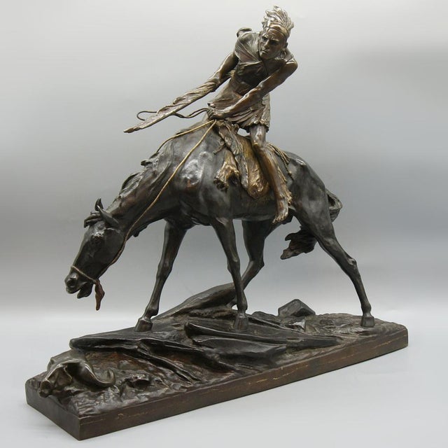 A patinated bronze sculpture of a native american warrior on horseback by èdouard drouot (1859-1945). Signed e. Drouot to...