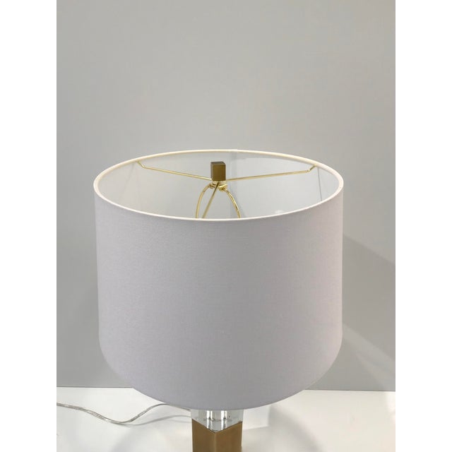 Stylish Bodil Crystal & Brass Lamp. Brass and clear base. White shade. Original retail $940. Showroom floor sample.