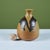 Textured studio pottery vase with variegated olive-green and tan glaze. The vessel has a tapered body with a tulip mouth....