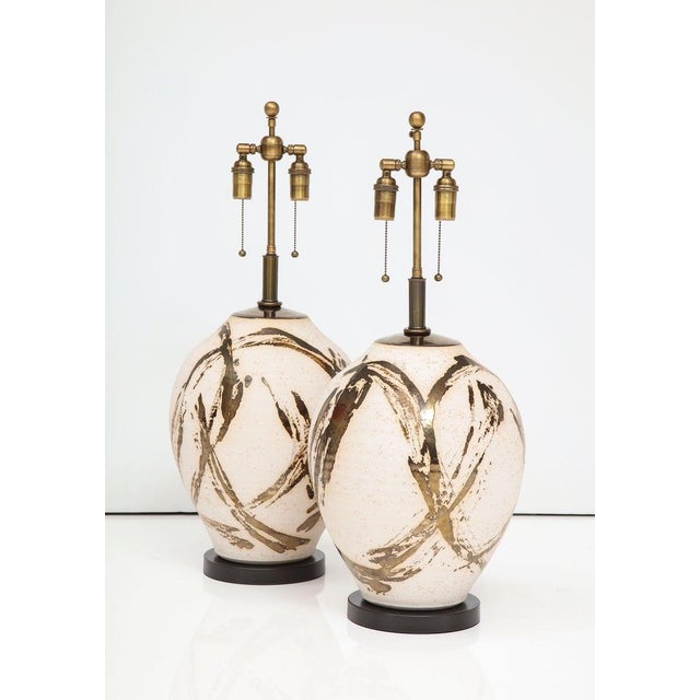 Large pair of Raku Ware lamps designed for a Steve Chase interior. The lamps have a wonderful Batik style Metallic glazed...