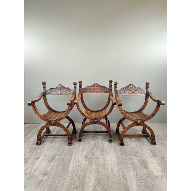 Set of Three Renaissance-Style Armchairs – 19th Century An elegant set of three curule armchairs in carved Renaissance-...