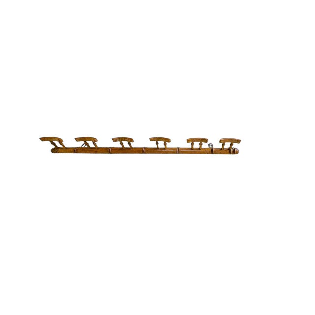 Elegant Coat Rack, crafted in France in the 1950s. It is made of wood in faux-bamboo style. with its six hooks, this...