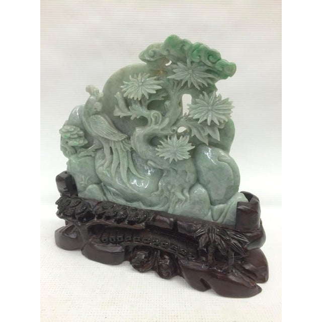 This is a beautiful Chinese model that depicts a mountain with people, houses, trees, and flowers. The piece exhibits very...