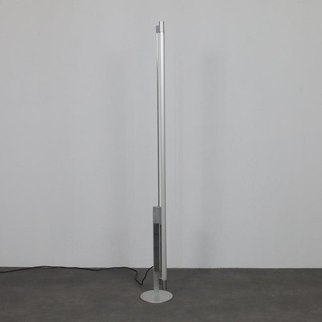 A striking example of late 20th-century swiss lighting design, this trapez floor lamp by erwin egli embodies architectural...