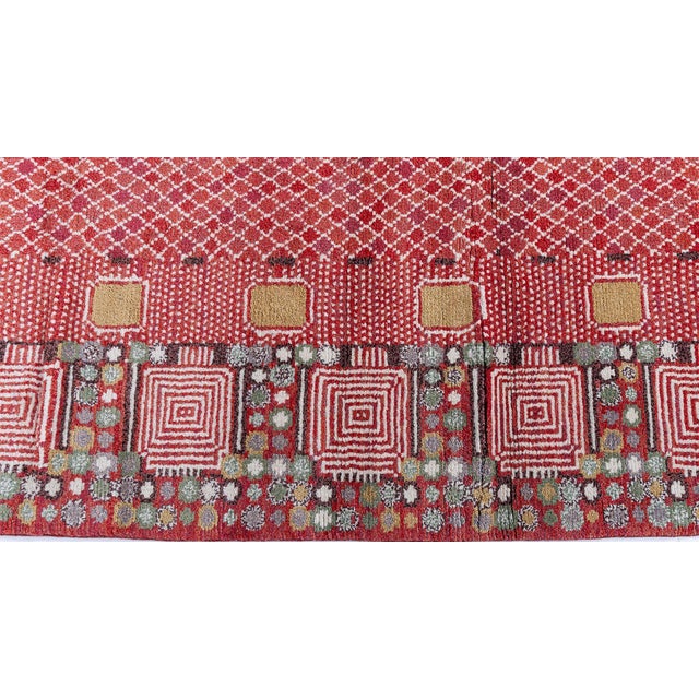 This contemporary Swedish pile rug features a richly textured red field enlivened by an intricate lattice pattern rendered...