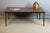 Large coffee table, iron frame and parquet-effect wood top. The four legs end in lion's paw feet. DIMENSIONS: 1.21m x...