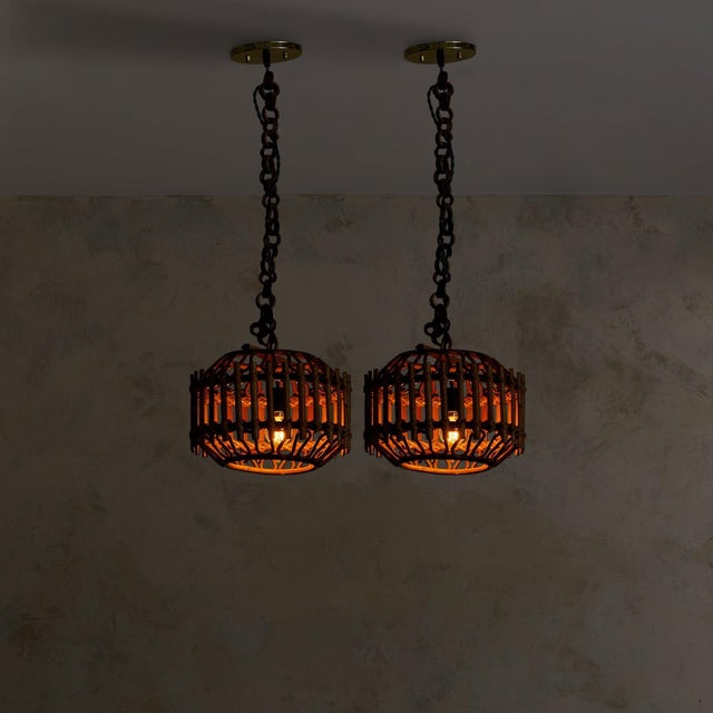 A 1960s Italian lantern pendant, its sculptural drum form woven from warm, honeyed bamboo in the manner of Franco Albini....