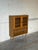 This charming storage piece features glass-paned upper doors with detailed leading and an open lower shelf. Supported by...