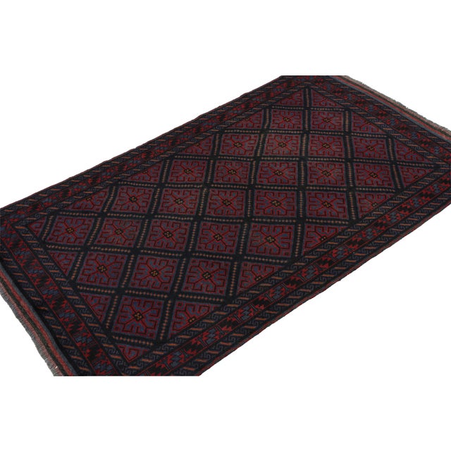 Hand-knotted in wool and goat hair circa 1950-1960, this 5x8 vintage Baluch tribal rug is a new curation from Rug & Kilim....