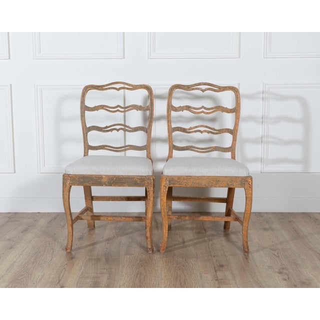 A charming pair of slender Gustavian chairs, Sweden, circa 1780. The gently curved ladder-backs feature the distinctive...