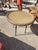 Small table in wood, wicker and wrought iron painted black. The round top is covered with an imitation wicker embossed...