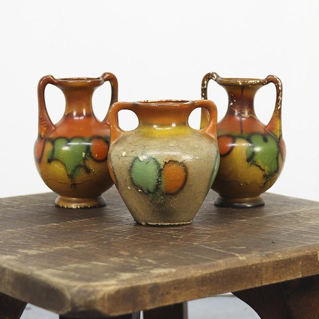 This beautiful set of three antique earthenware vases dates from Belgium, circa 1920. Each vase is hand-colored in...