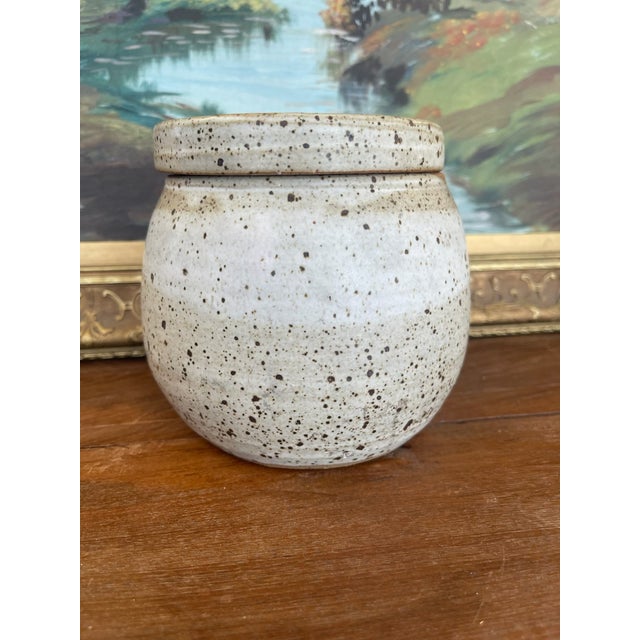 This unique lidded studio pottery jar, signed and dated "Alice 78" on the base, exemplifies the organic style and...