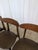 Vintage wooden dining chairs dating to the 1960s–1970s. The chairs have a simple mid-century modern design with solid wood...
