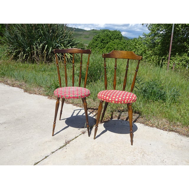 Pair of nearly identical chairs, made of solid beech with a dark oak stain. Fan-shaped spindle backrest with a curved...