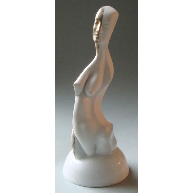 The "women figure on a pedestal" is a decorative art piece made of porcelain and silver. The height of the figure is 20...