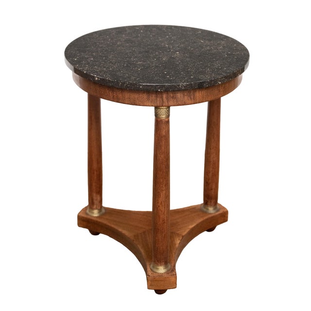 A handsome French round table or gueridon in the Empire style, featuring a circular top of figured black marble (19 3/4"...