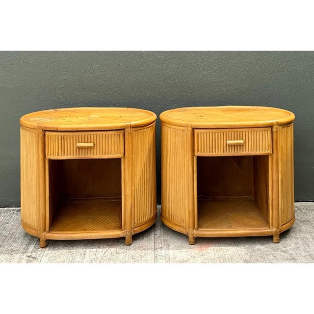 This pair of vintage rattan oval nightstands captures the laid-back sophistication of mid-20th-century tropical modern...