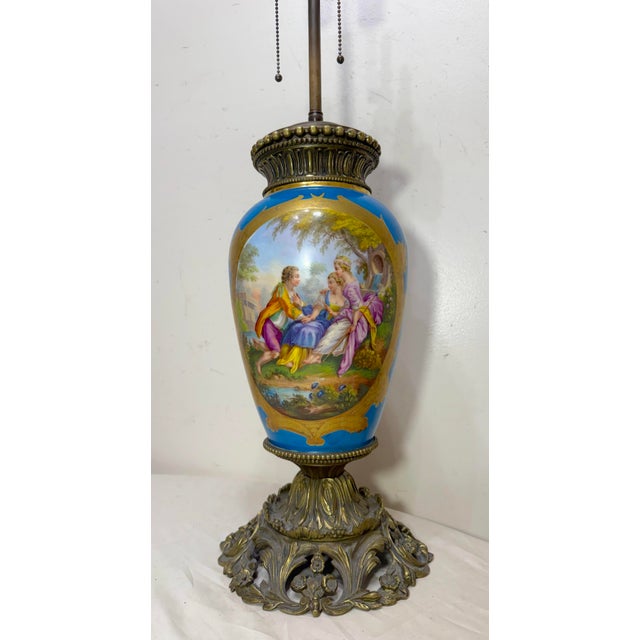 Experience the elegance of the Louis XVI era with this exquisite Sevres porcelain and bronze electric table lamp. The lamp...
