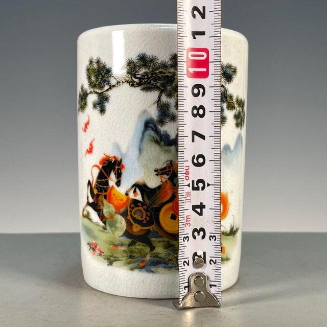 A charming Chinese porcelain brush pot (bitong). The cylindrical vessel features a creamy, all-over crackle glaze and is...