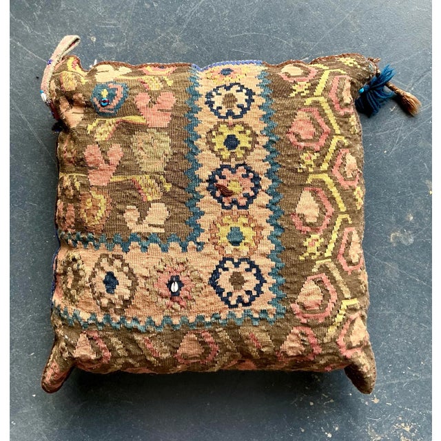 This substantial vintage throw pillow is crafted from genuine hand-woven Kilim rug fragments, featuring rich textural...
