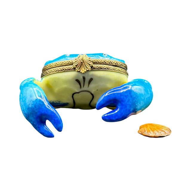 A whimsical hand-painted Limoges porcelain box modeled as a naturalistic blue crab, rendered in vivid turquoise and cobalt...