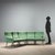 1960s corner sofa composed of four armchairs and a corner element, featuring an original period green fabric seat. The...