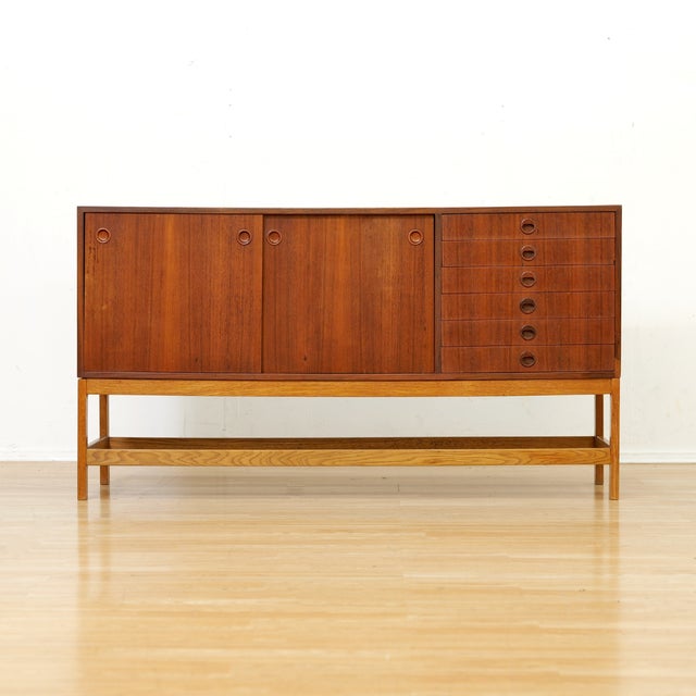 This vintage mid-century credenza was produced in Sweden during the early 1960s. This sleek credenza features a bank of...