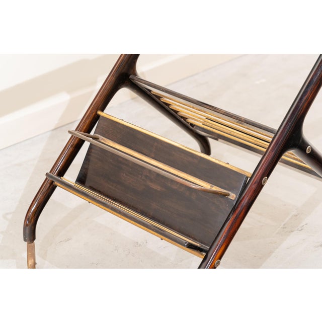 A mid-century Italian serving trolley from the 1950s, crafted from stained beech wood, brass, and glass. from bottom to...