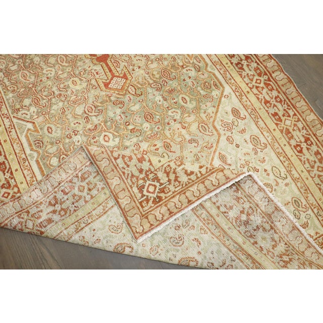A wide antique persian senneh runner from the early 20th century