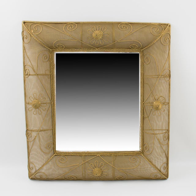 This elegant 1950s rectangular gilt metal wall-mounted mirror features stunning dimensional domed sides with raised...