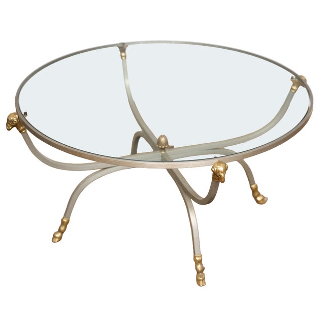A fine French round cocktail or coffee low table from the Mid-Century Modern period, featuring a circular glass top set...