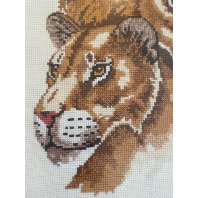This professionally framed textile art is created with meticulously crafted wool needlepoint. The lion and lioness are...