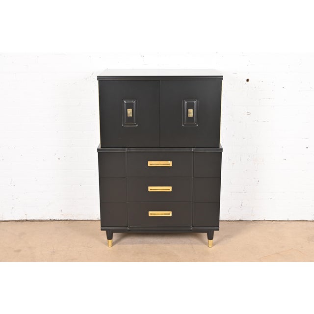 An exceptional Mid-Century Modern Hollywood Regency or Campaign style highboy dresser or gentleman's chest By John...