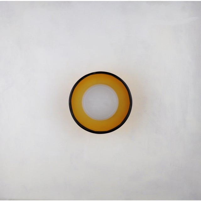 This small wall light is crafted from hand-blown glass, offering a delicate yet expressive presence. Its compact scale...