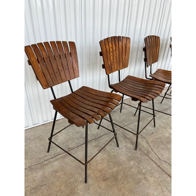 In the style of Arthur Umanoff! These are lovely wooden and iron chairs with plenty of character and patina. The bases...