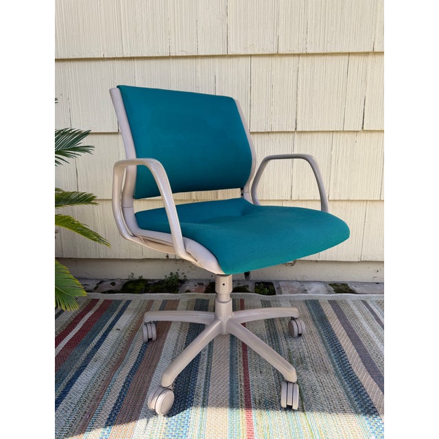 Vintage Steelcase teal blue rolling office desk chair produced in 1984 features mid-century modern style, fabric-...