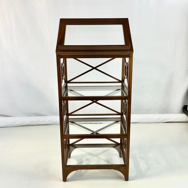 This is a stunning display Etagere that has target designs down each side. The wood frame is finished in a chestnut stain...