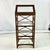 This is a stunning display Etagere that has target designs down each side. The wood frame is finished in a chestnut stain...