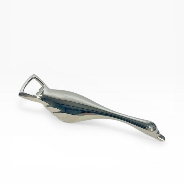 A great addition to a bar cart! Vintage mid century silver plate goose or swan bottle opener. Has a nice weight to it....