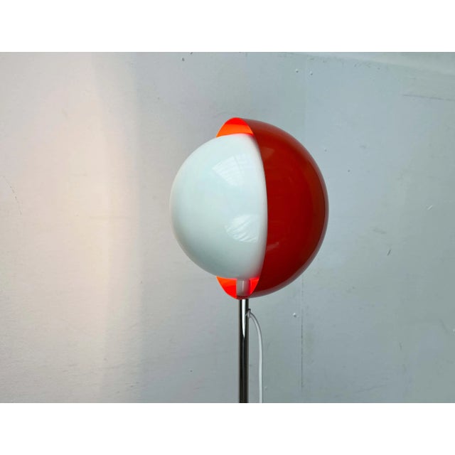 Rare Space Age floor lamp with an eclipse effect. The spherical reflector sits at the top of a long shaft. It consists of...