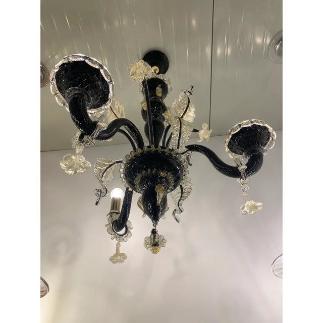 Classical black and gold Murano glass chandelier with flowers and leaves. Traditional piece of Italian art of blowing...