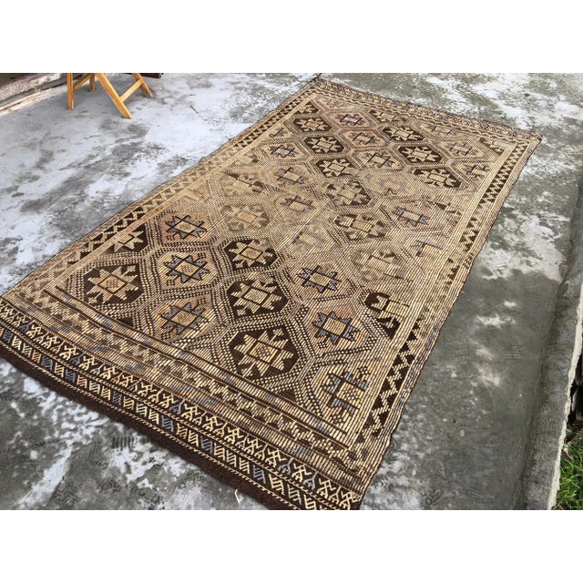 This is a vintage Turkish Anatolian kilim rug from the 1960s. The piece was hand-woven.