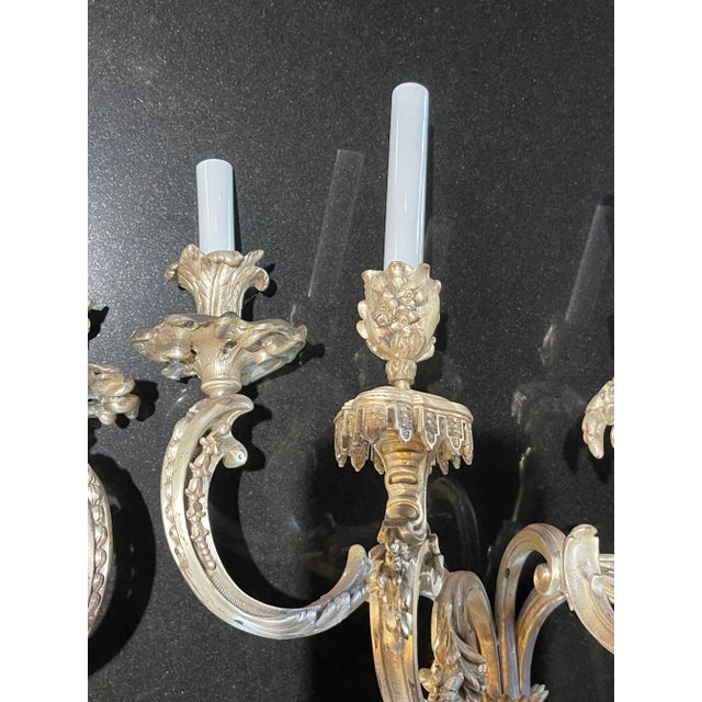 A fine Louis XV silver plated over bronze five arm wall sconce from the Belle Époque period. Five as rose from a foliate...